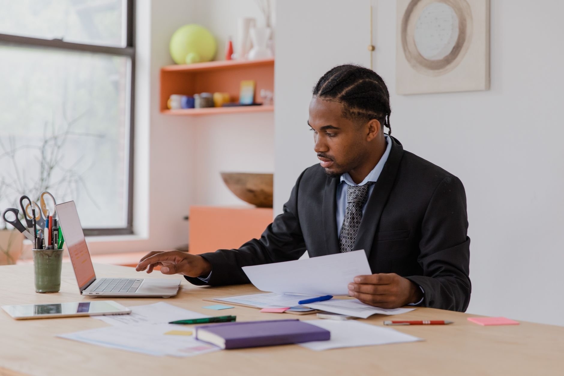Business owner working with documents and laptop in a modern office