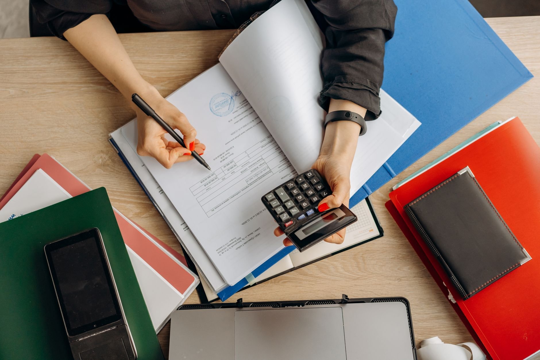 Accountant reviewing financial documents at a clean desk